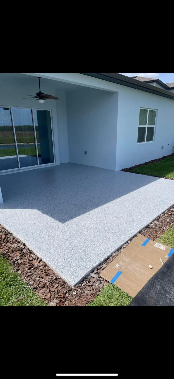 Light decorative flake coating on an exterior covered entryway slab