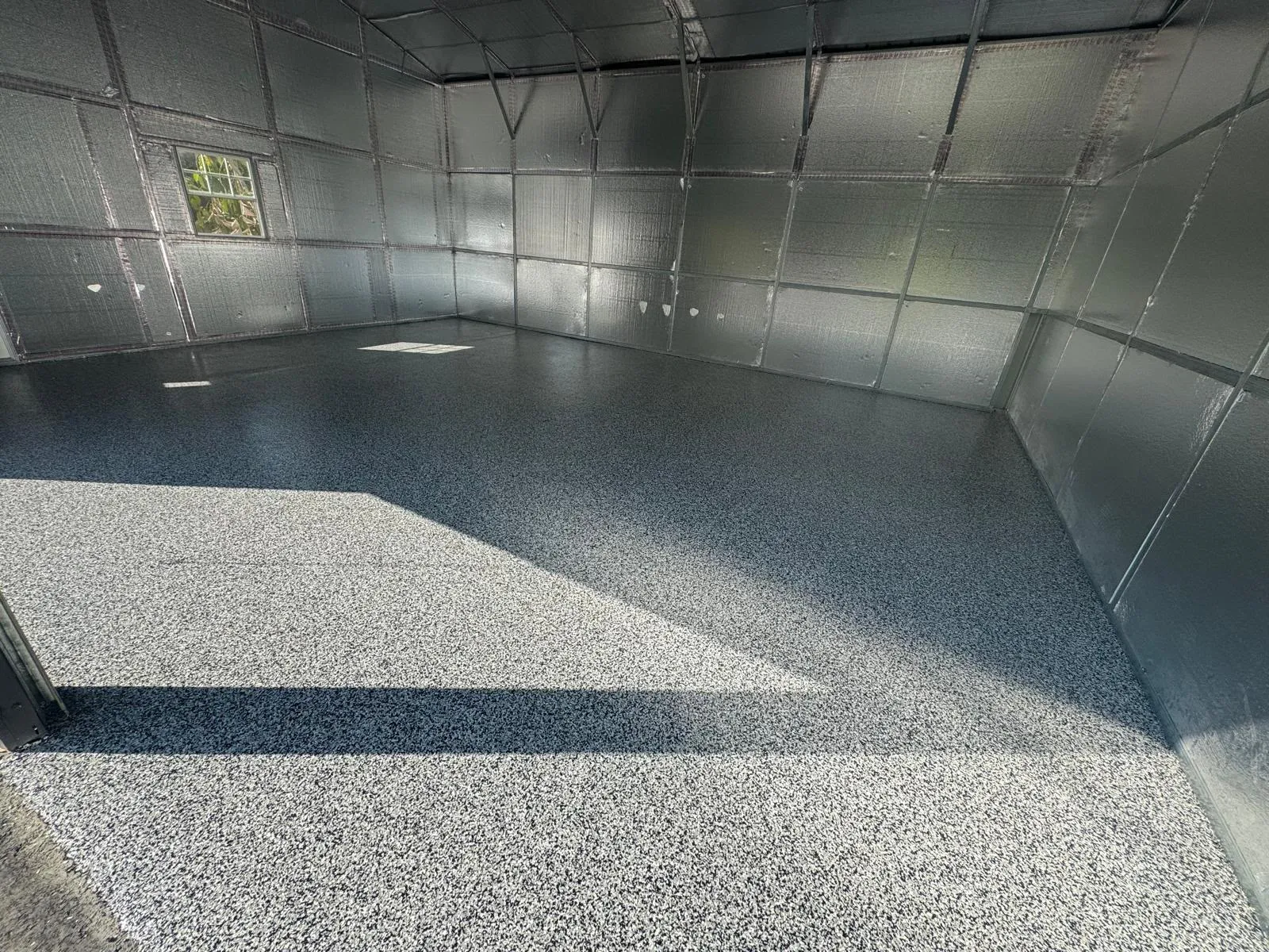 Full-broadcast grey decorative flake floor in a finished residential garage