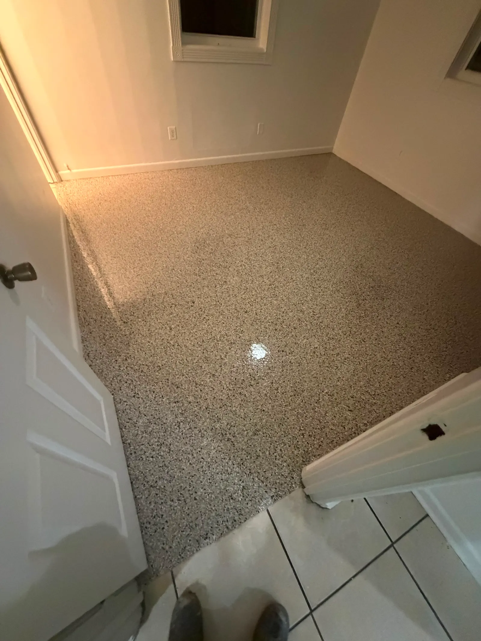 Warm tan decorative flake flooring finished with a glossy sealer in a residential room