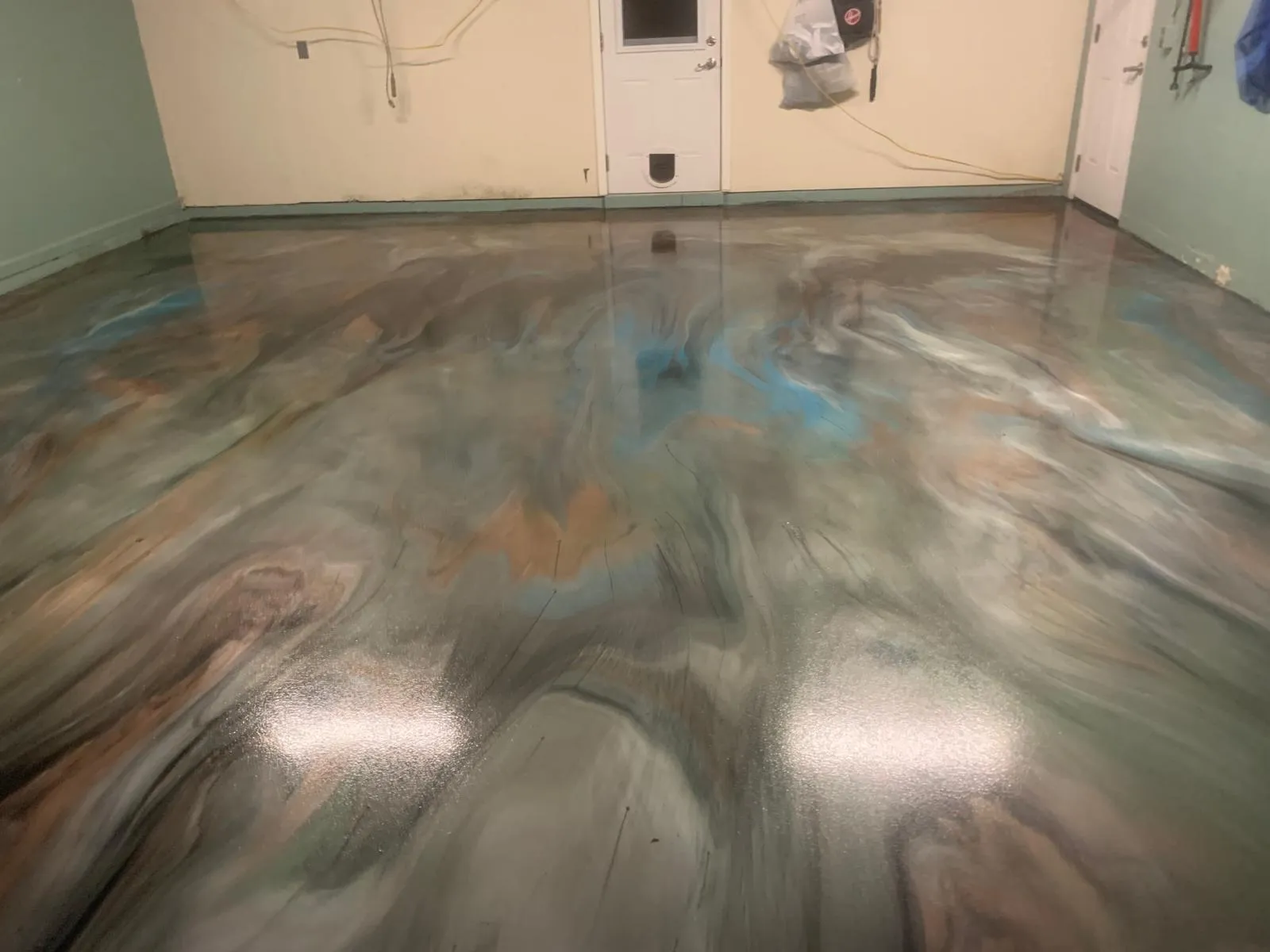 Silver and blue marbled metallic epoxy floor in a bright interior room