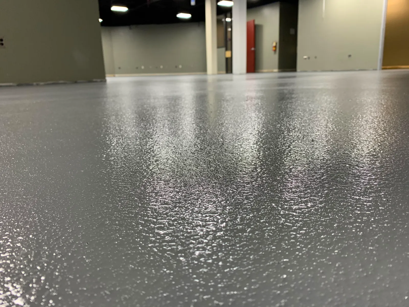Slip-resistant grey quartz broadcast floor with a textured finish in a commercial facility