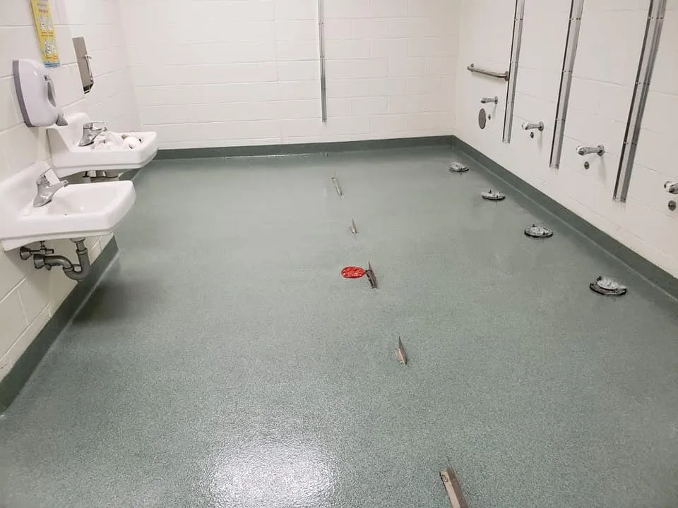 Decorative quartz floor with coved edges in a commercial washroom