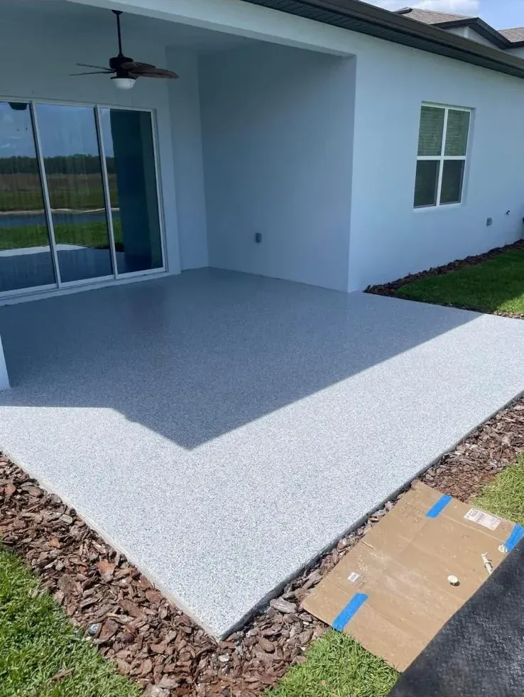 Light decorative flake coating on an exterior covered entryway slab